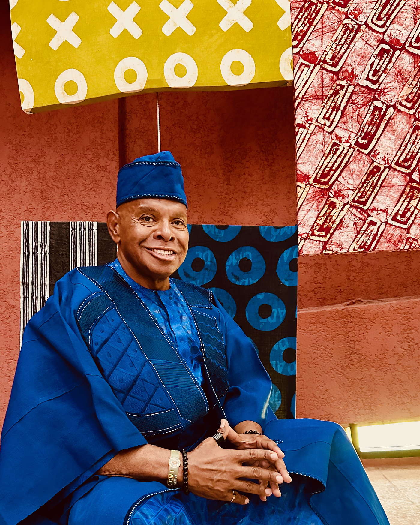 Rev. MacArthur H. Flournoy IV seated in a royal blue agbada in Lagos, Nigeria